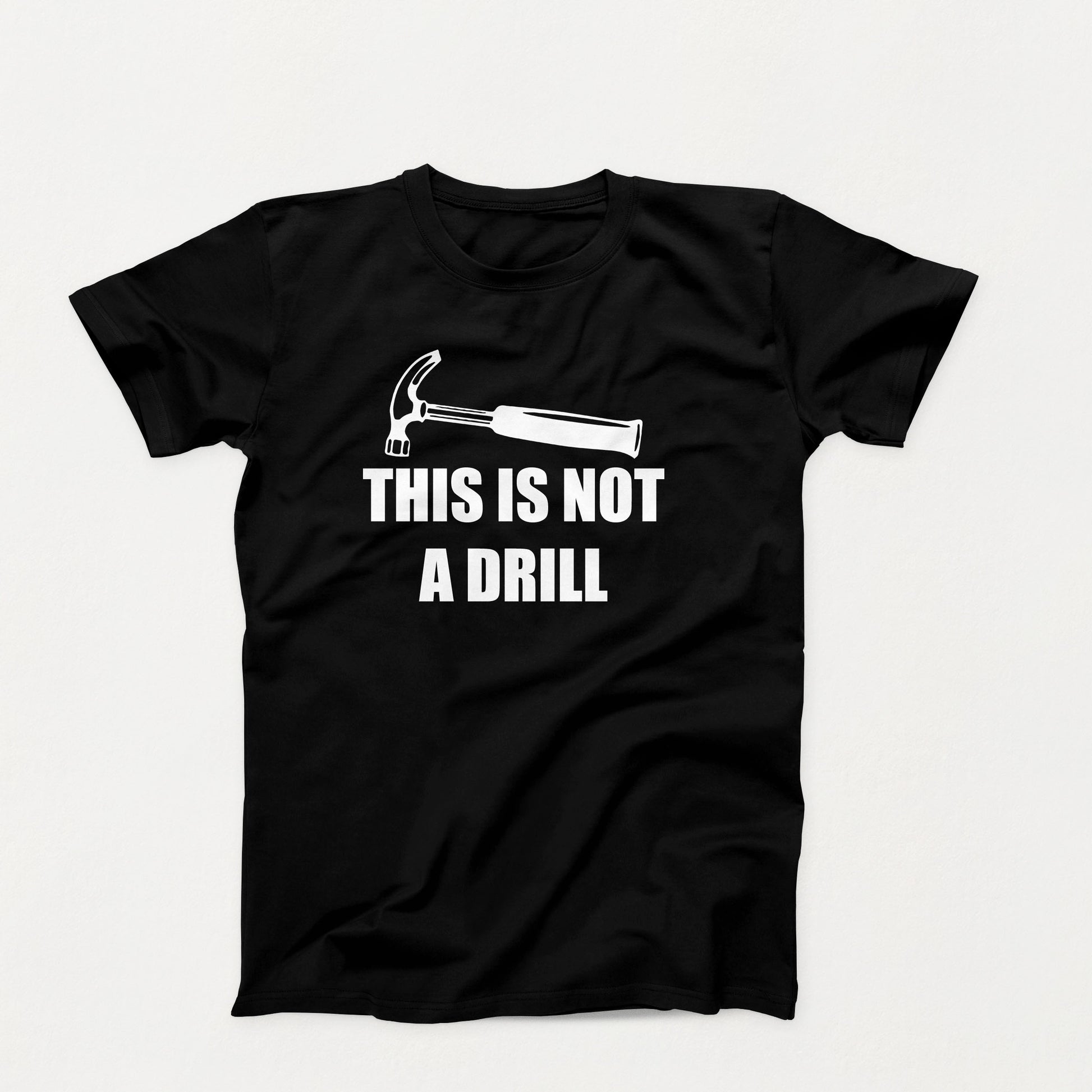 Funny t-shirt design with a hammer and the phrase “This Is Not a Drill” in bold white text on a black t-shirt