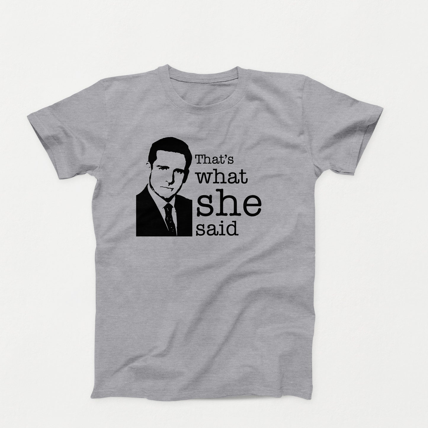 Black shirt design with a silhouette of a man in a suit and the phrase “That’s What She Said” in bold typewriter font on a gray shirt