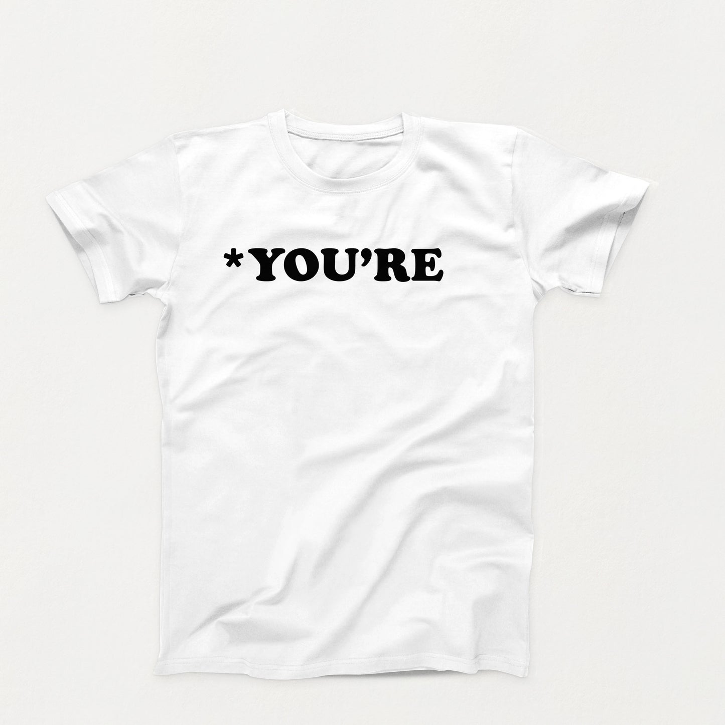 white t-shirt with white text that reads “*You’re” in bold typewriter-style font, correcting grammar with silent judgment
